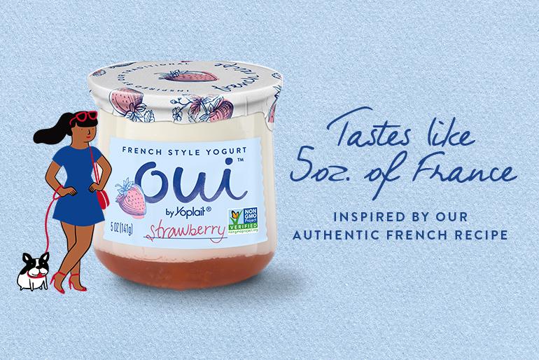 Jar of strawberry Oui by Yoplait yogurt on a blue background with text that reads Tastes like 5 ounces of France. Inspired by our authentic French recipe.